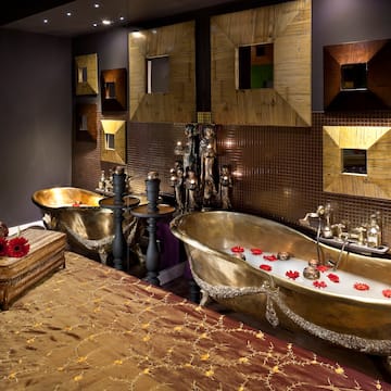 a bathroom with a bed and bathtubs