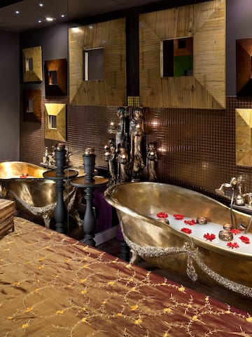 a bathroom with a bed and bathtub