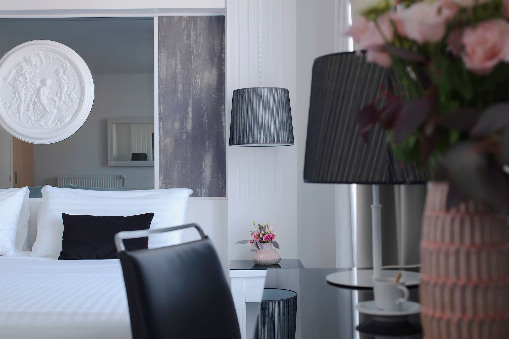 a room with a bed and a table and lamp