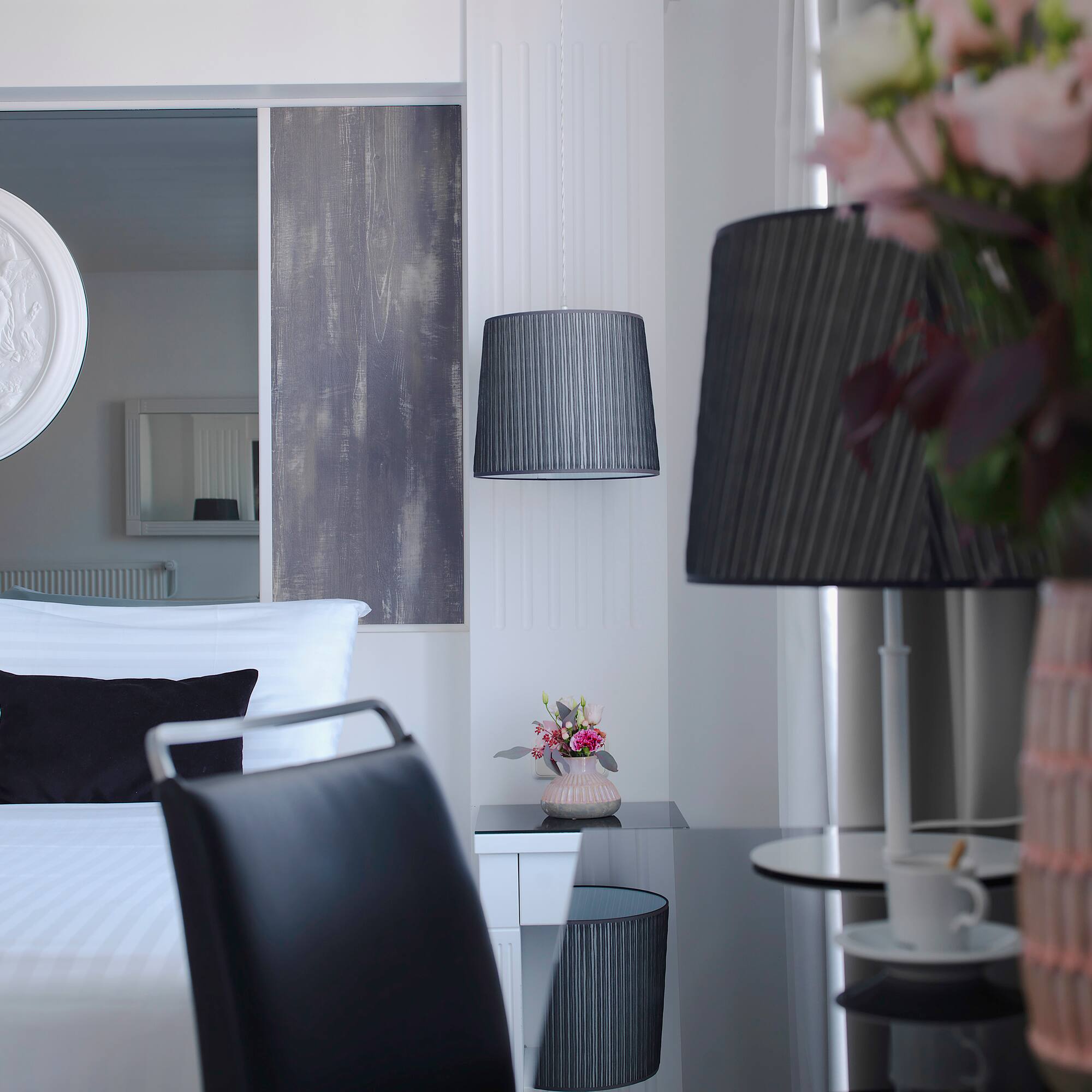 a room with a bed and a table and lamp