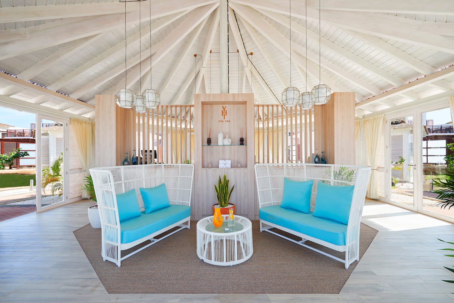 a room with a white ceiling and blue couches