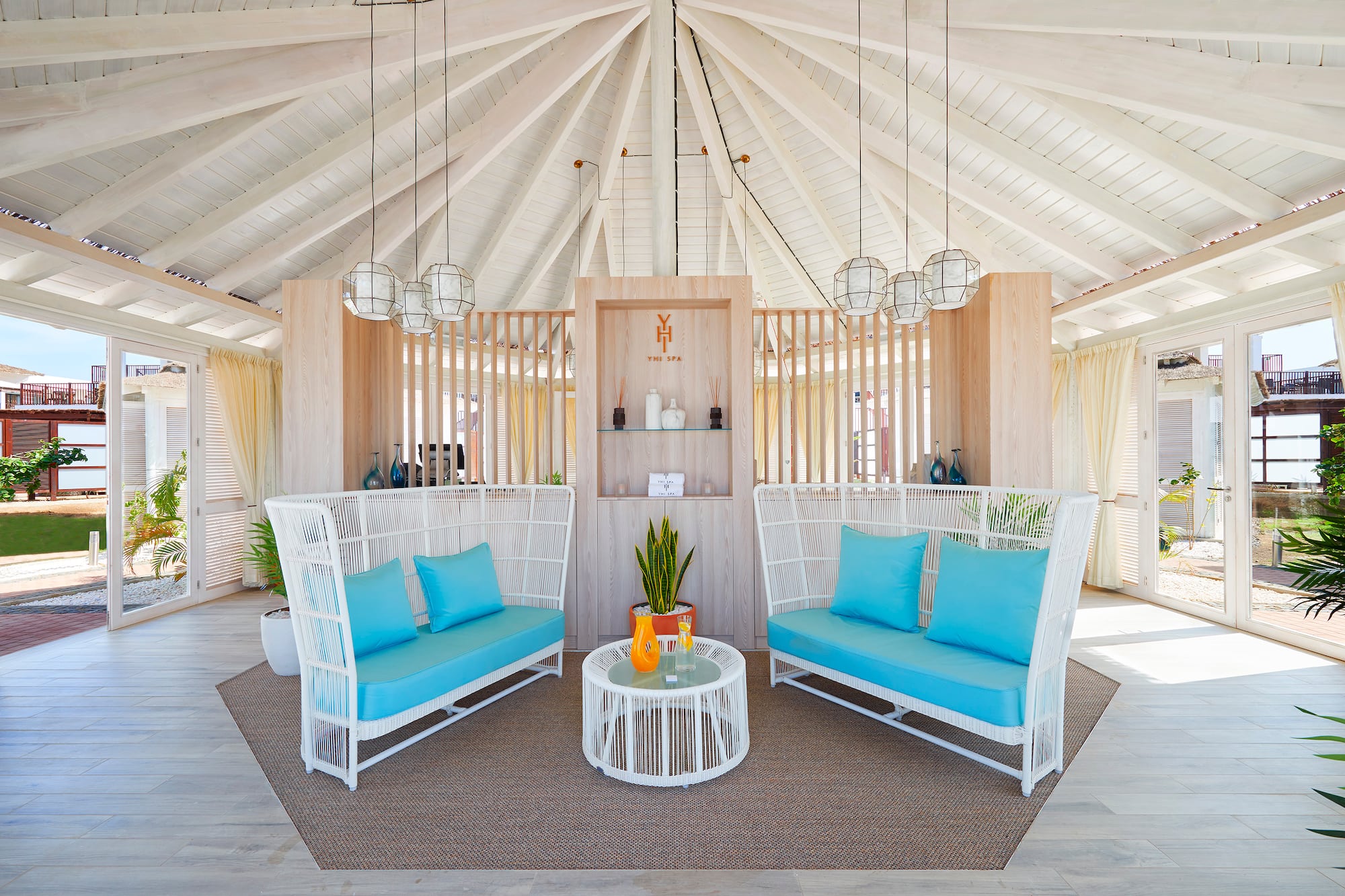 a room with a white ceiling and blue couches