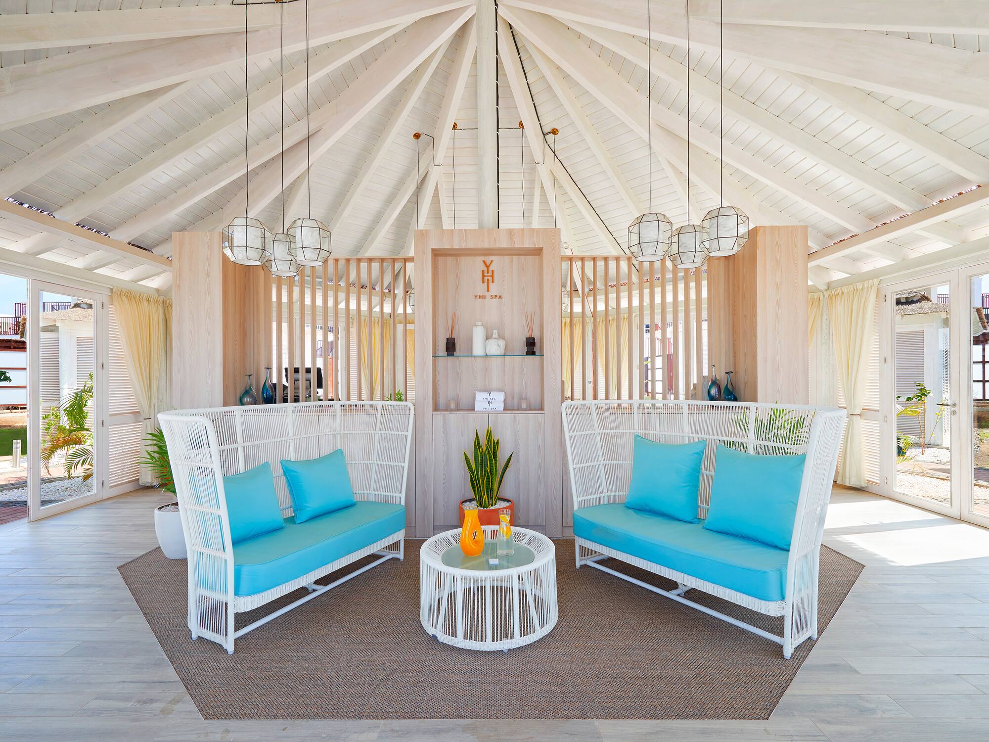 a room with a white ceiling and blue couches