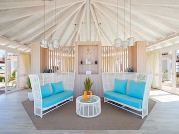 a room with a white ceiling and blue couches