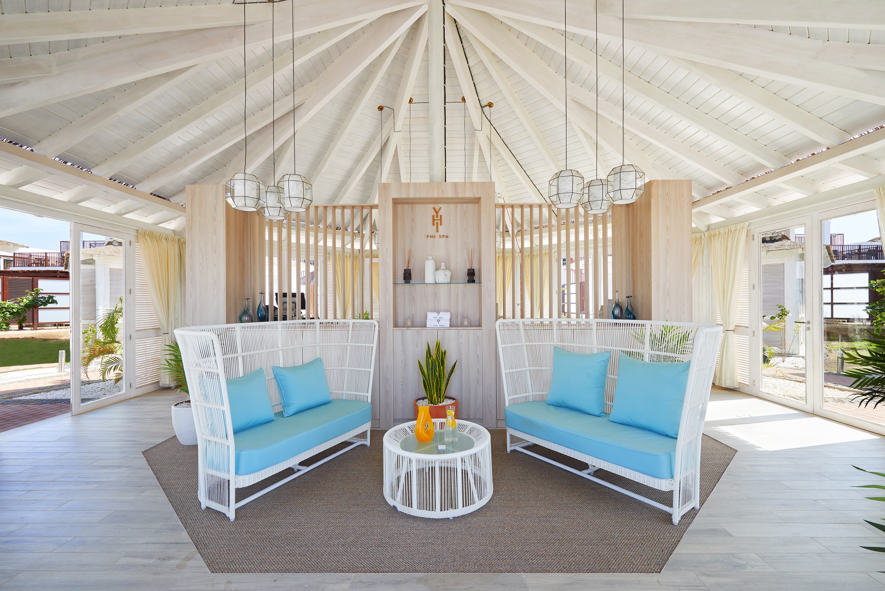 a room with a white ceiling and blue couches