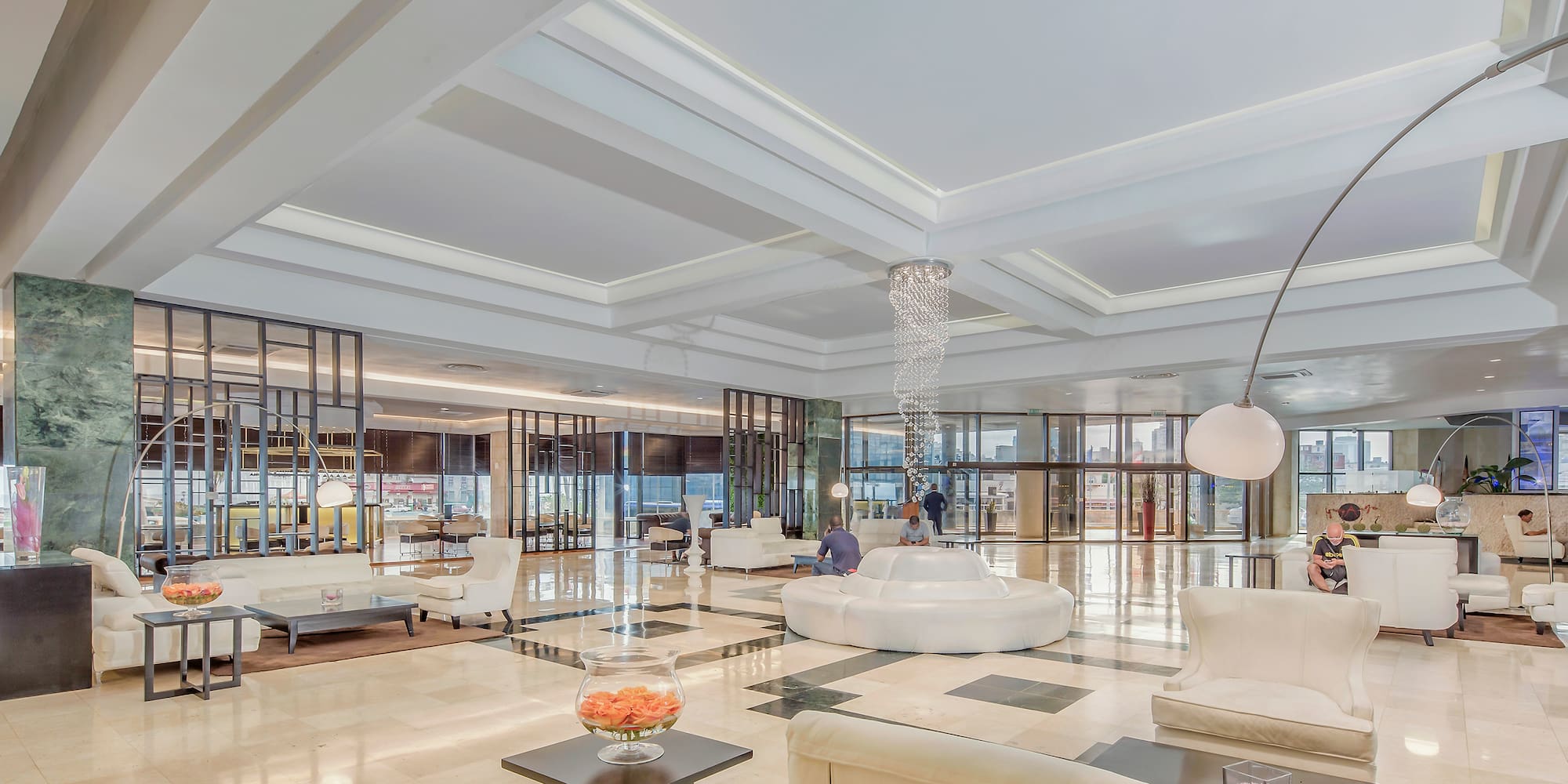 a large room with white furniture and a large chandelier
