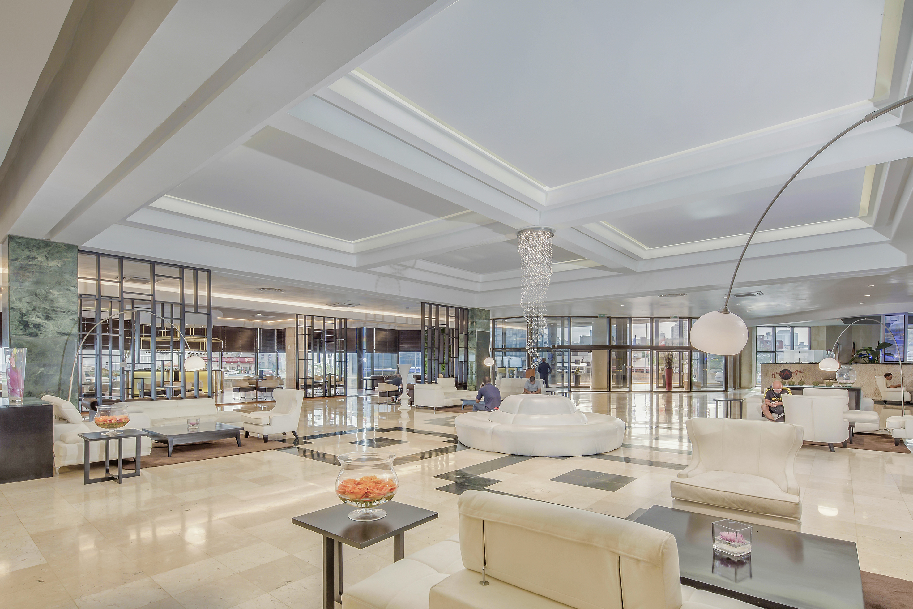 a large room with white furniture and a large chandelier