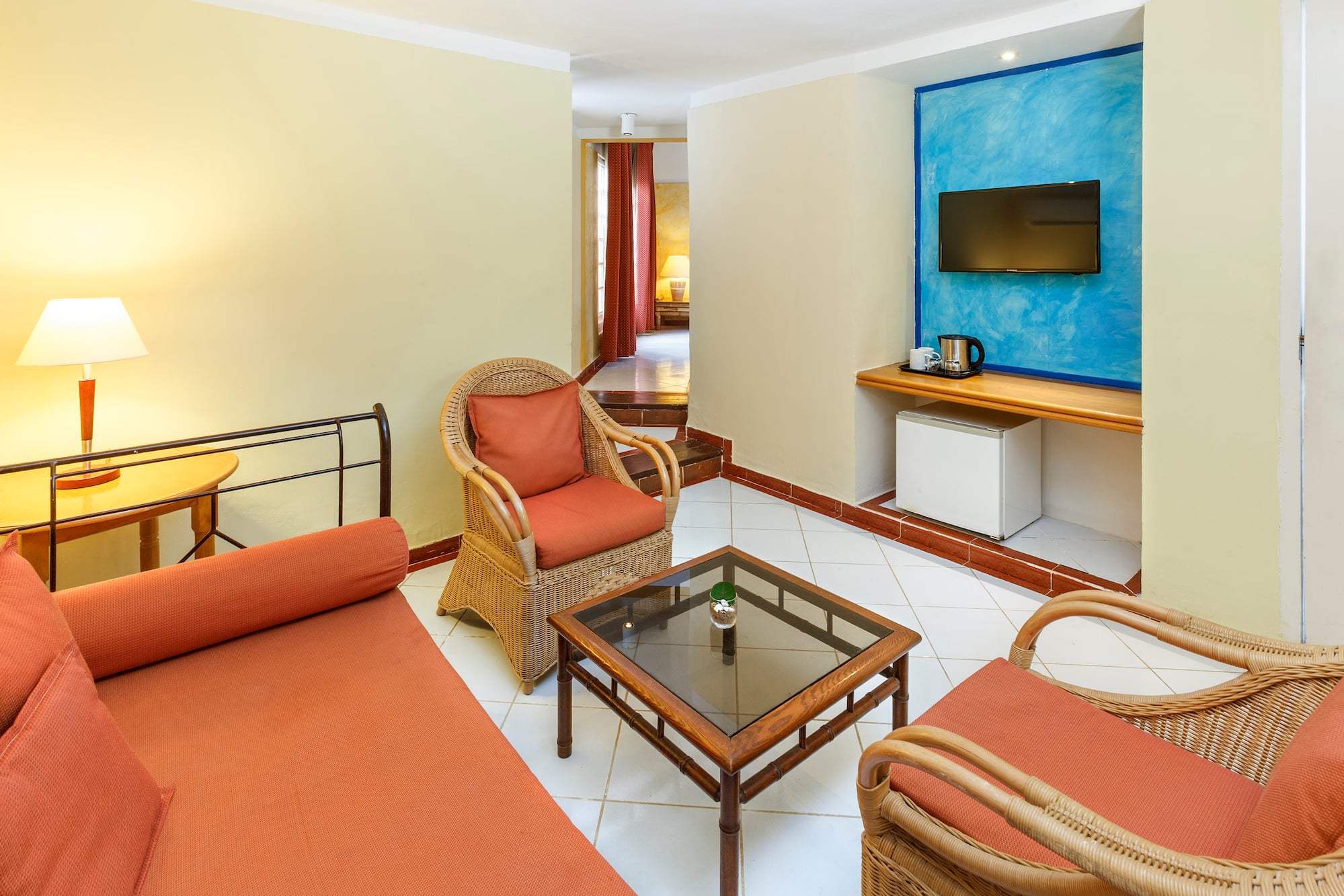 a room with a bed and chairs