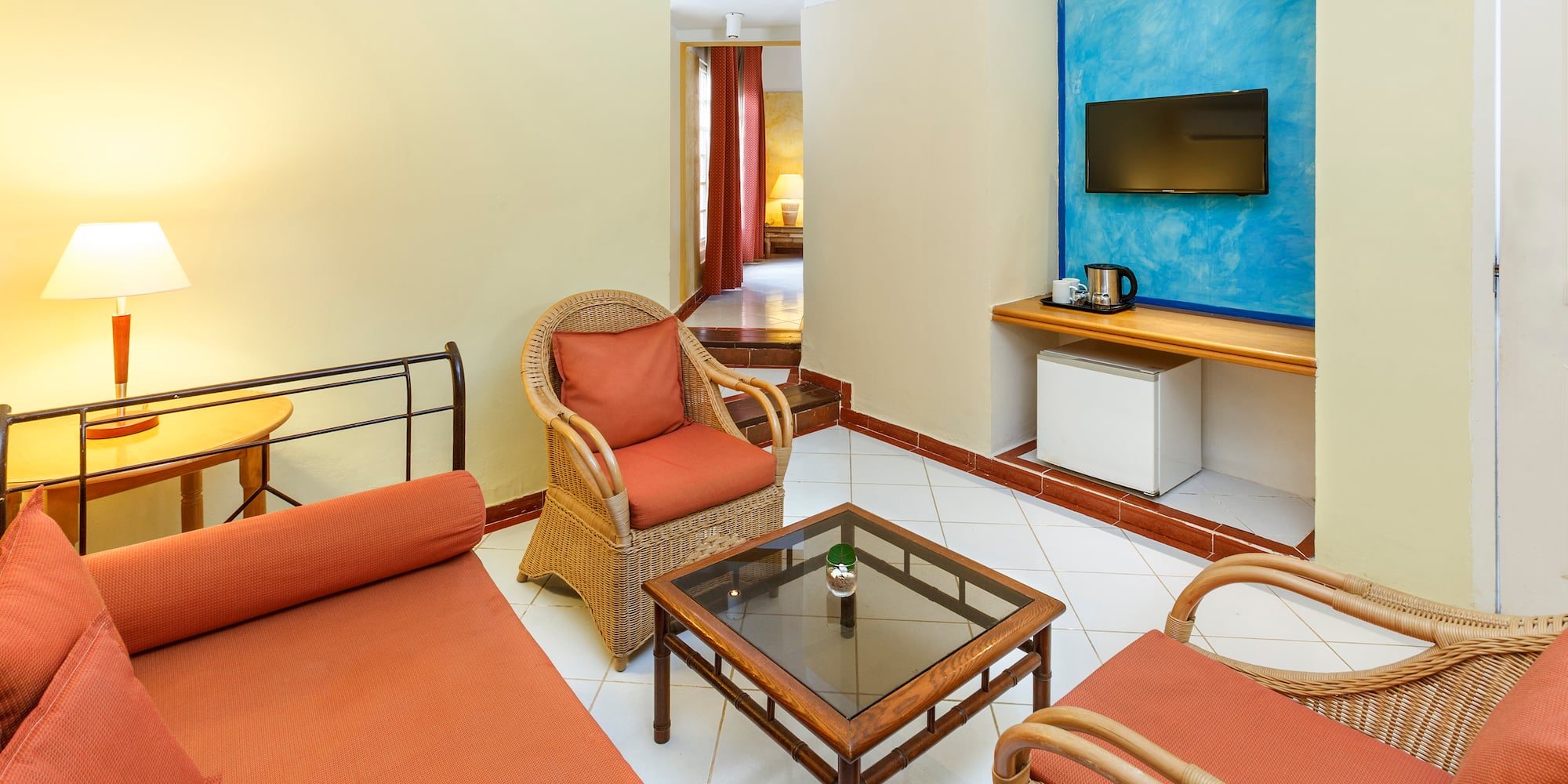 a room with a bed and chairs