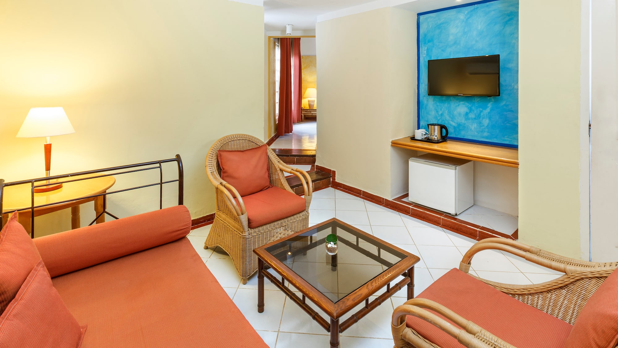 a room with a bed and chairs