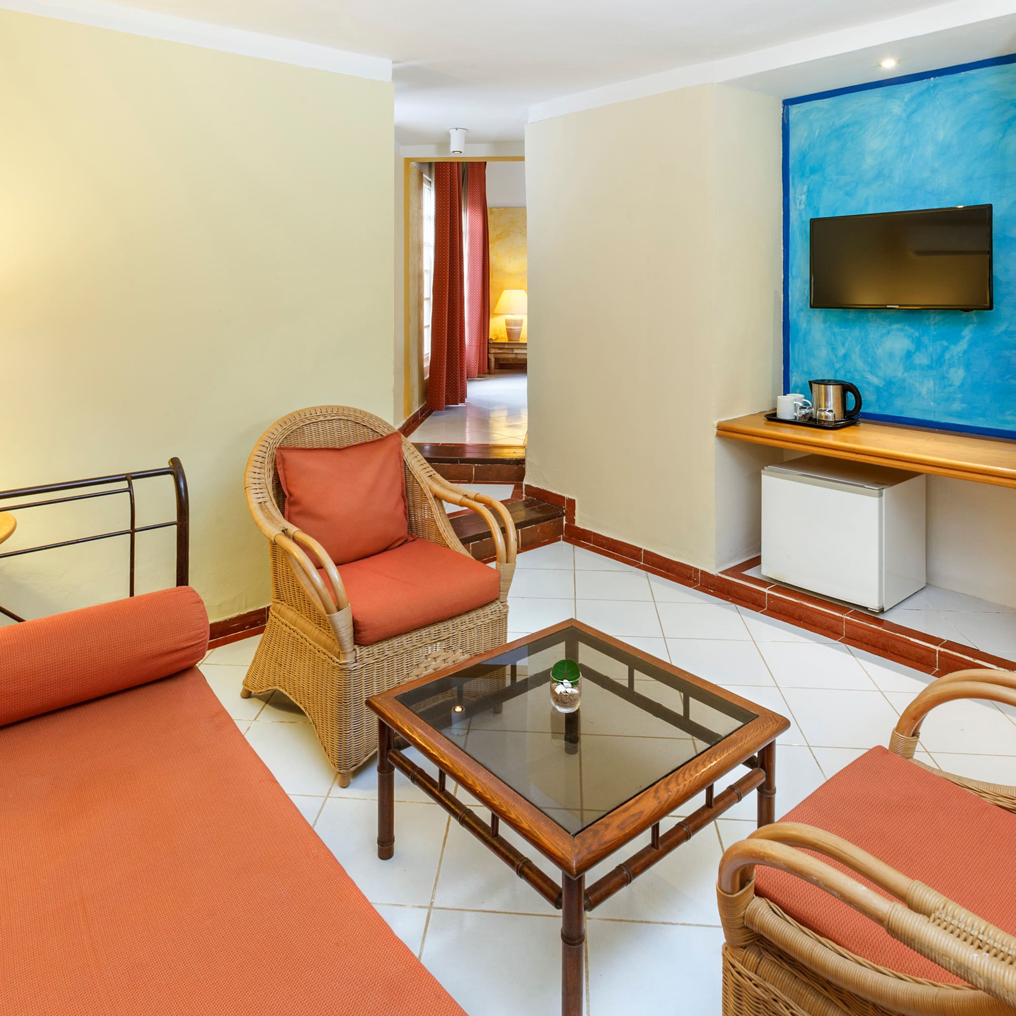 a room with a bed and chairs