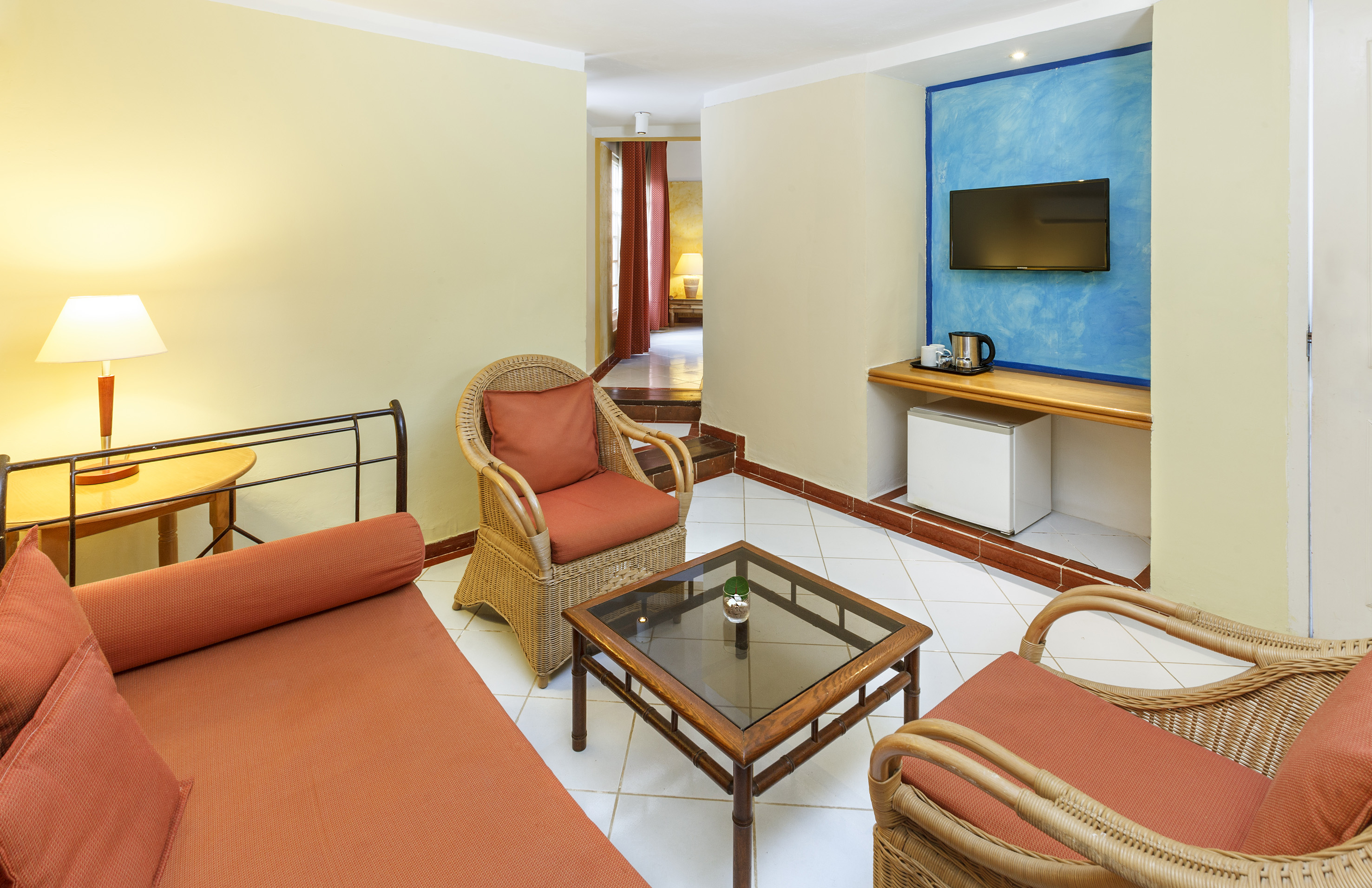 a room with a bed and chairs