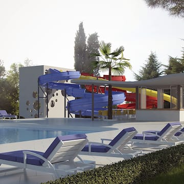 a pool with a slide and lounge chairs