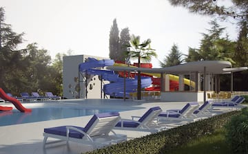 a pool with a slide and lounge chairs