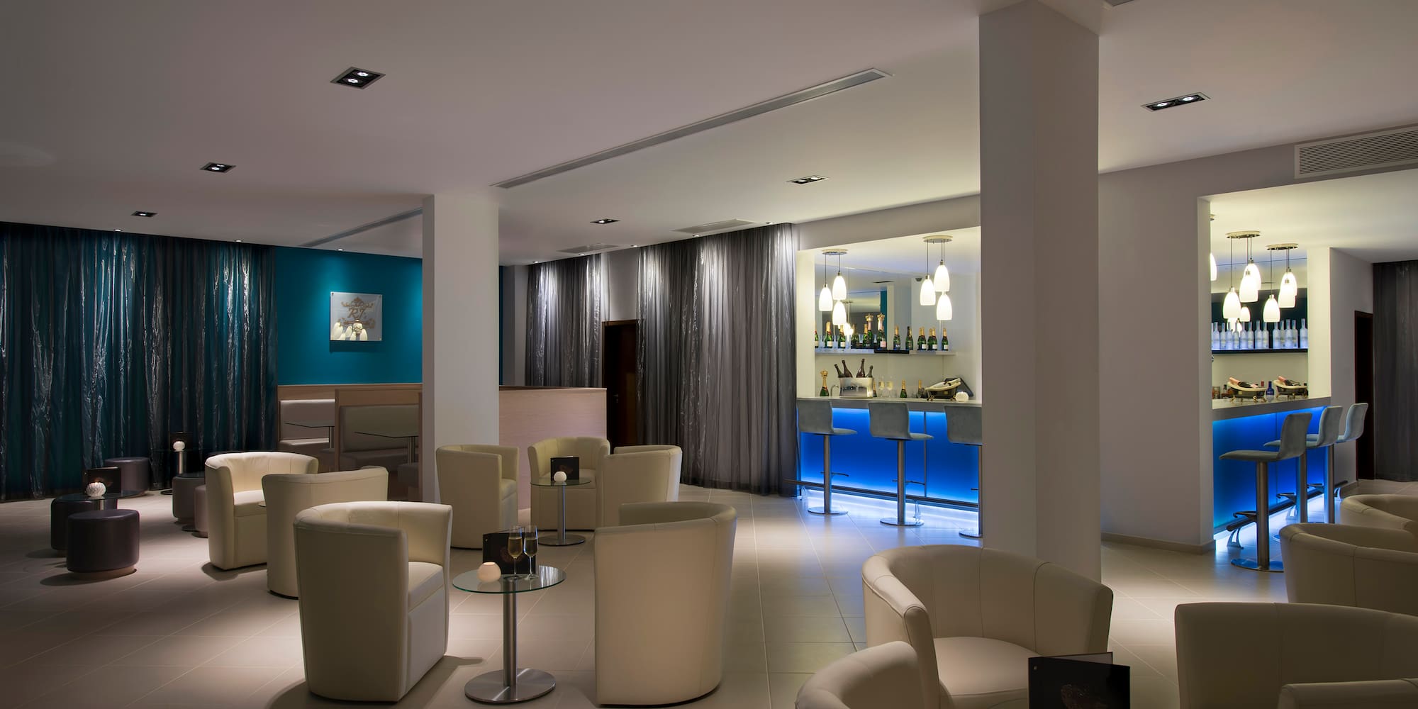 a room with white chairs and tables