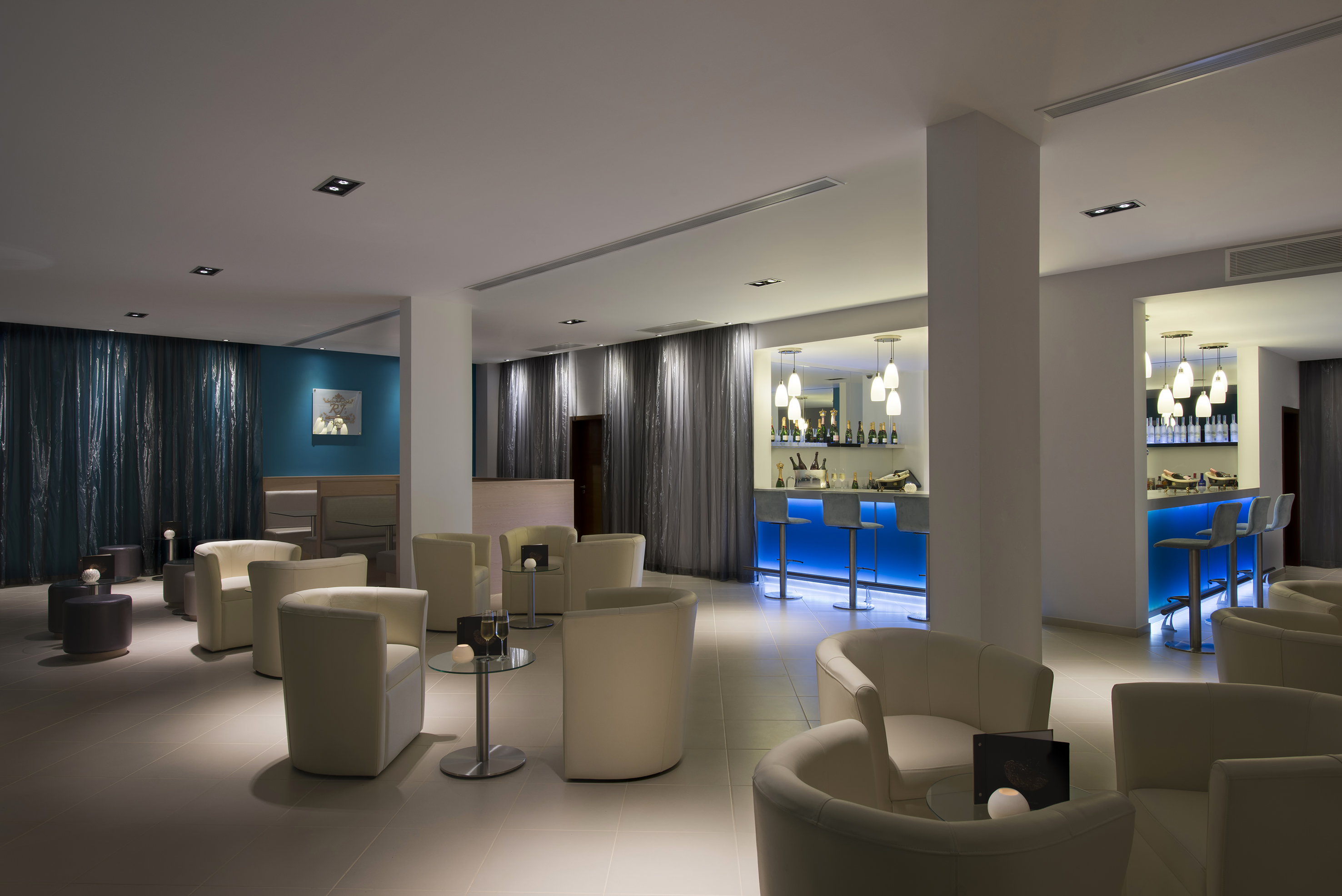a room with white chairs and tables