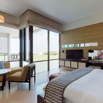 a room with a bed and a television