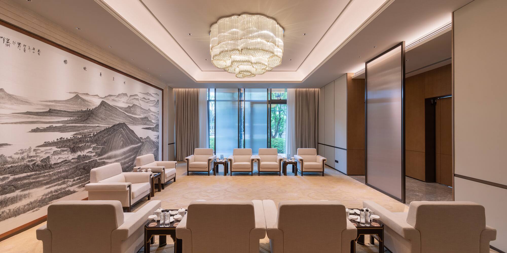 a room with white furniture and a large chandelier