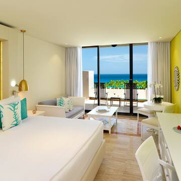 a room with a bed and a table and chairs