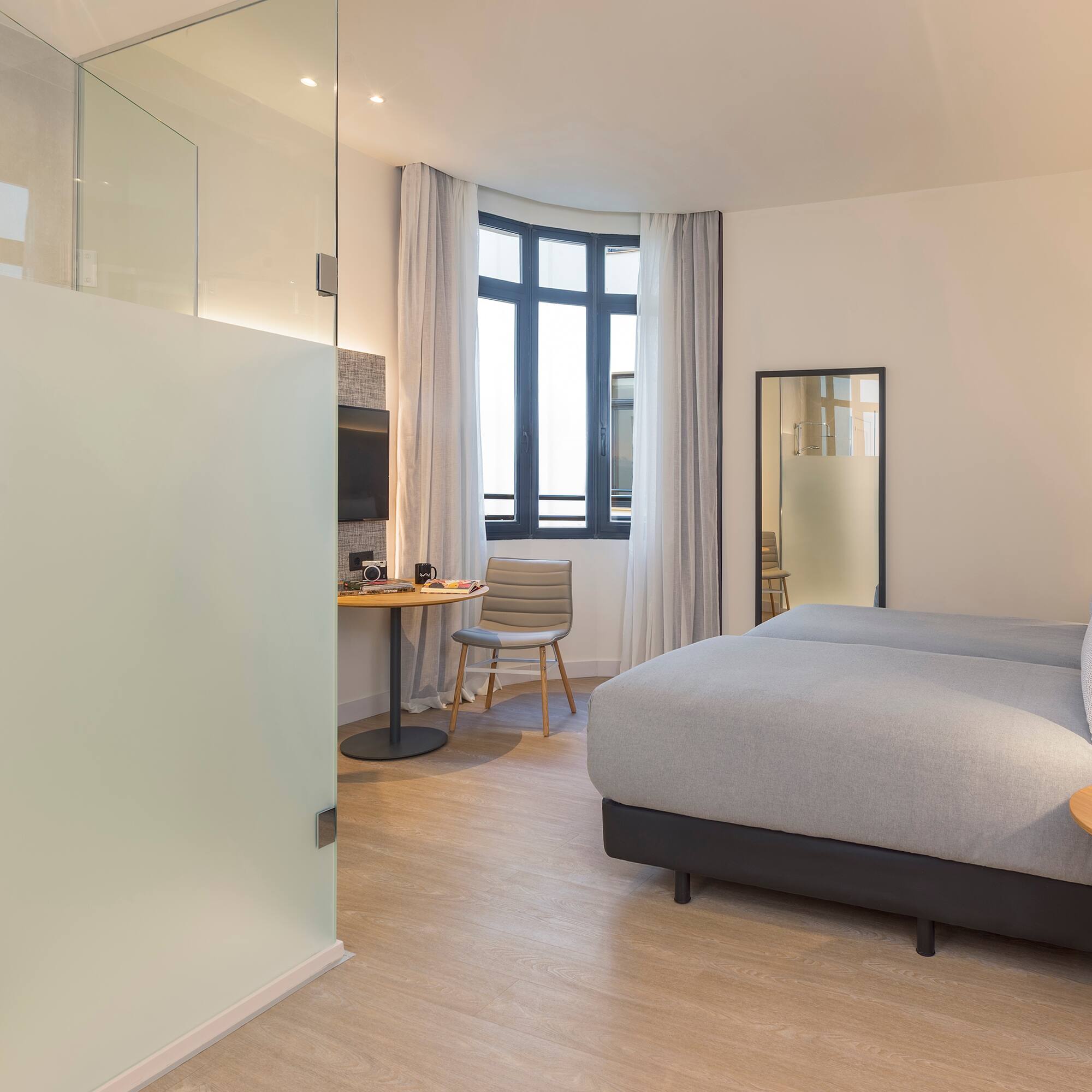 a bedroom with a bed and a desk