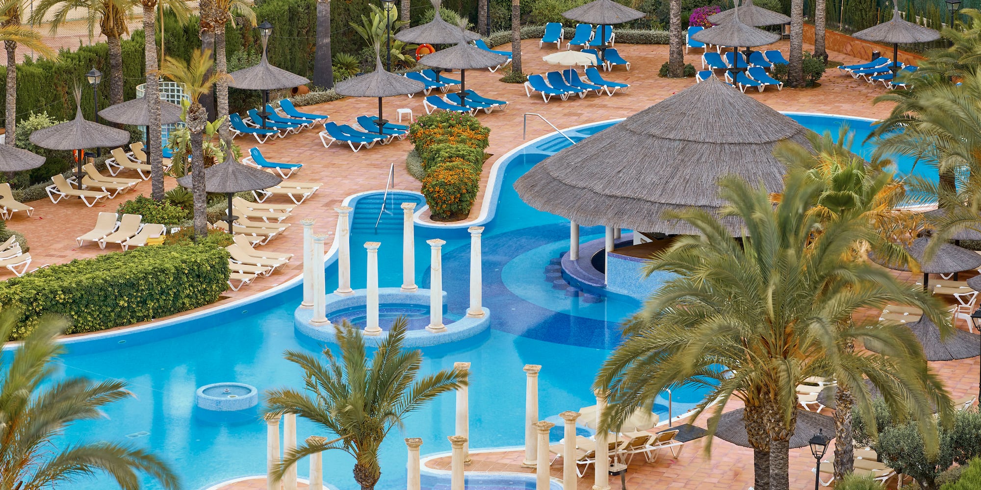 a pool with umbrellas and chairs