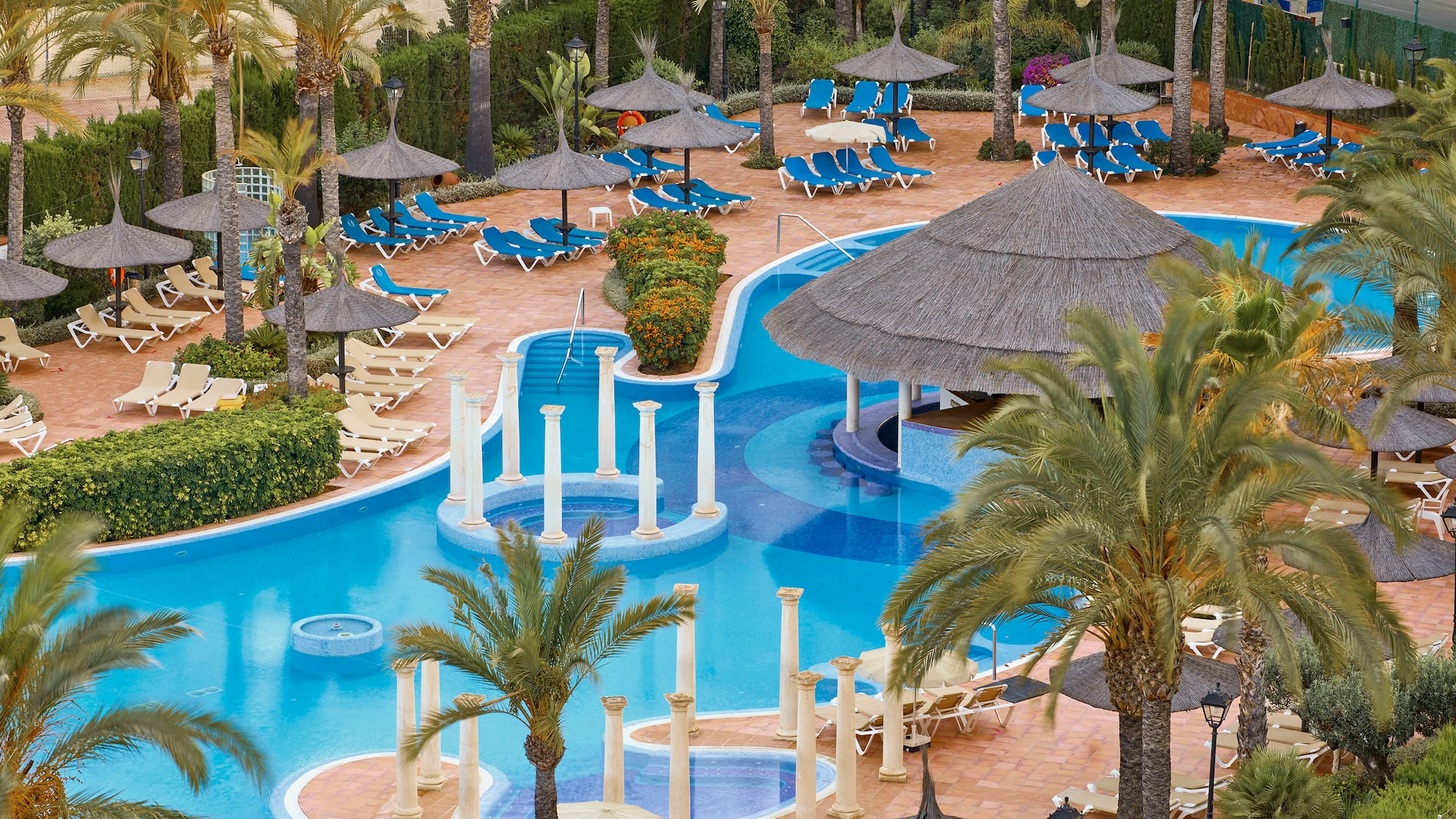 a pool with umbrellas and chairs