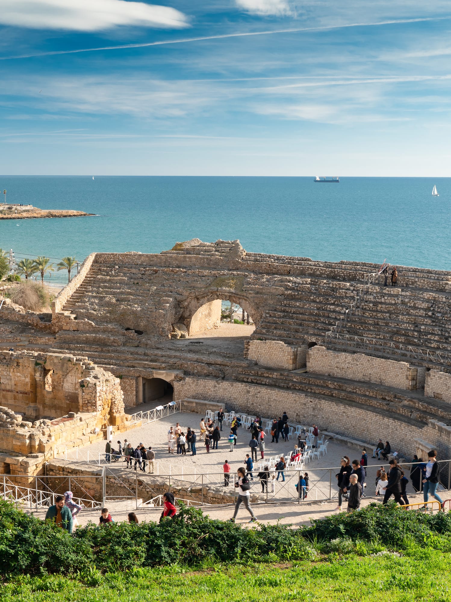 a group of people walking around an ancient amphitheater