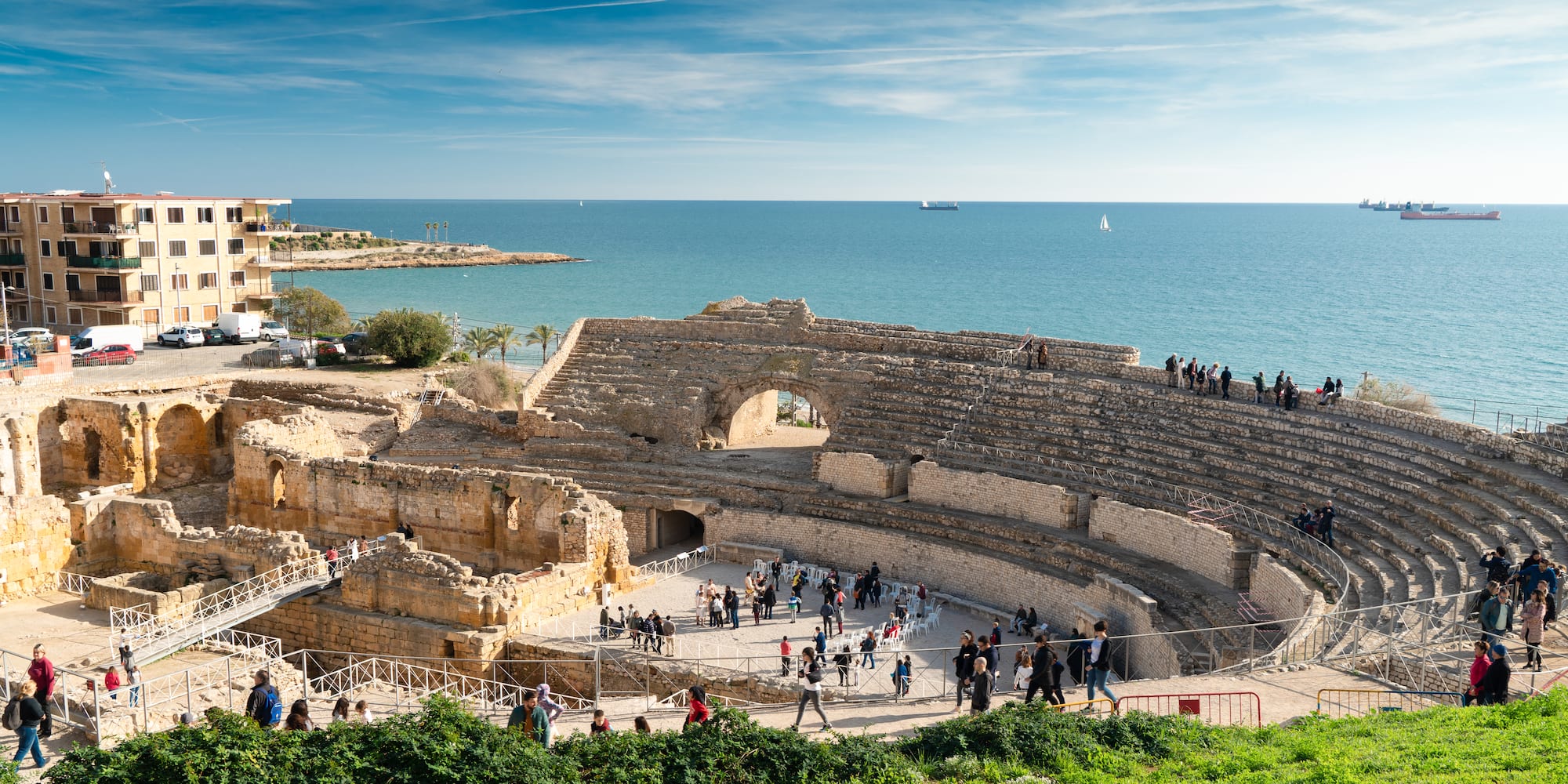 a group of people walking around an ancient amphitheater