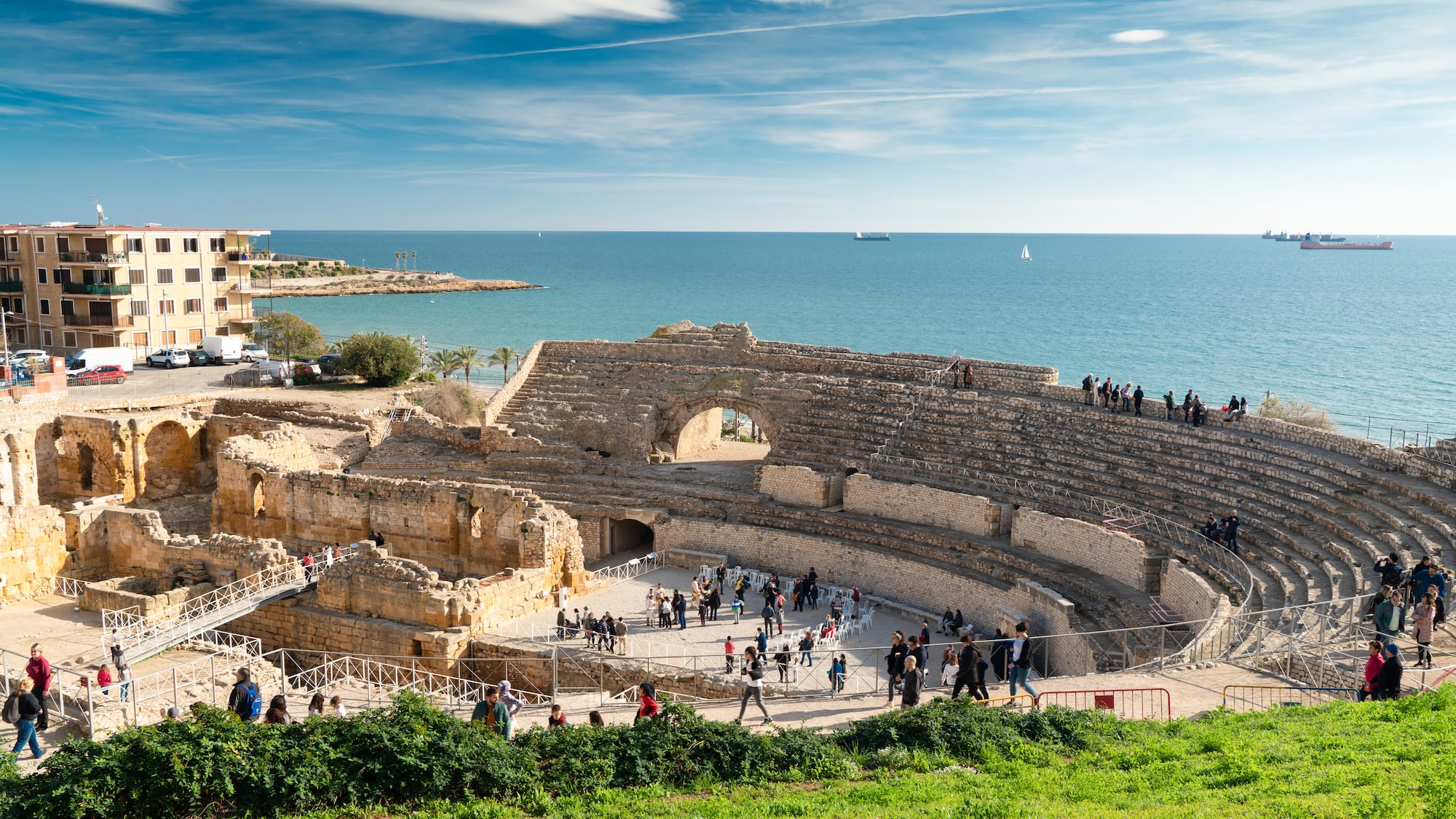 a group of people walking around an ancient amphitheater
