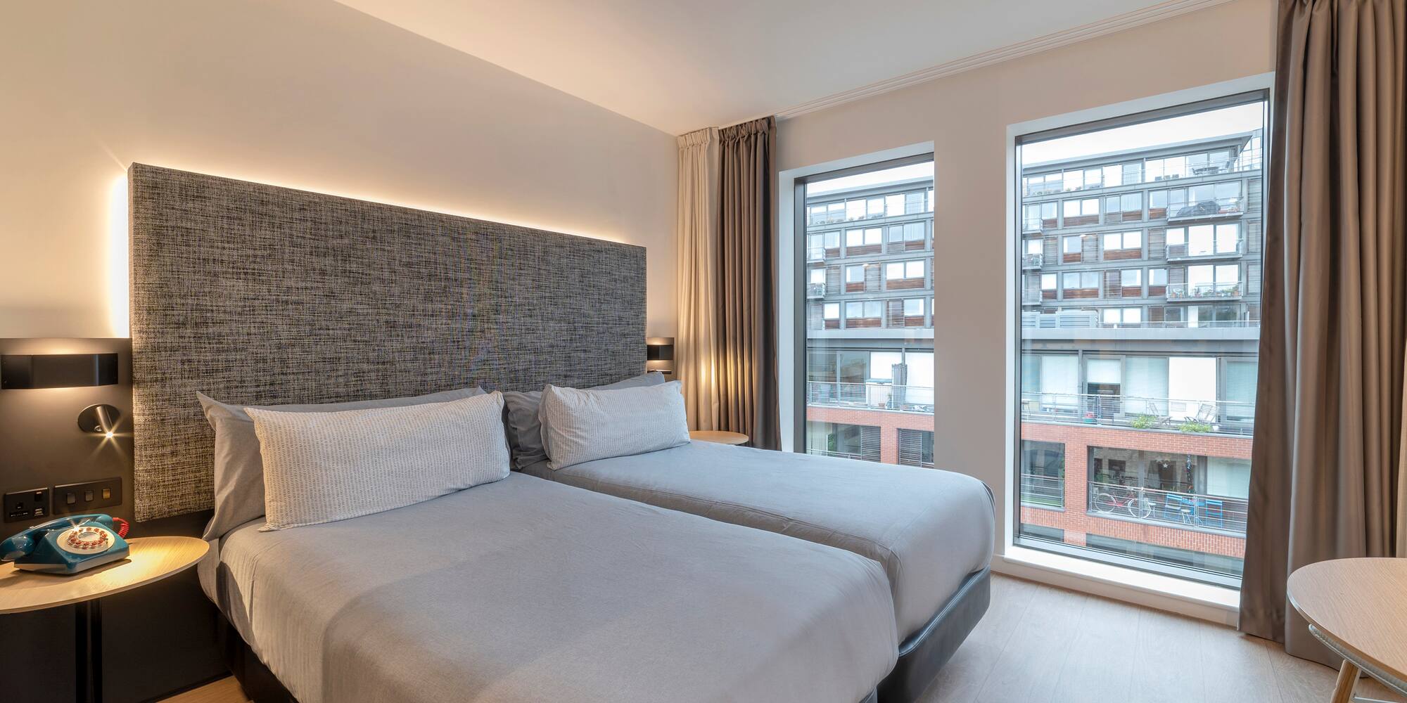 a room with two beds and a window