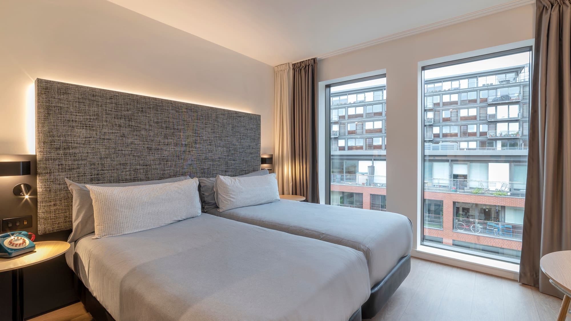 a room with two beds and a window