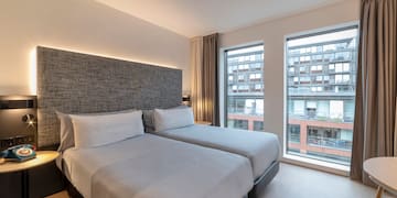 a room with two beds and a window