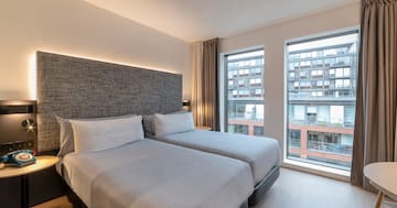 a room with two beds and a window