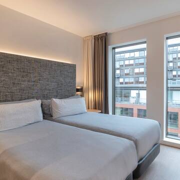 a room with two beds and a window