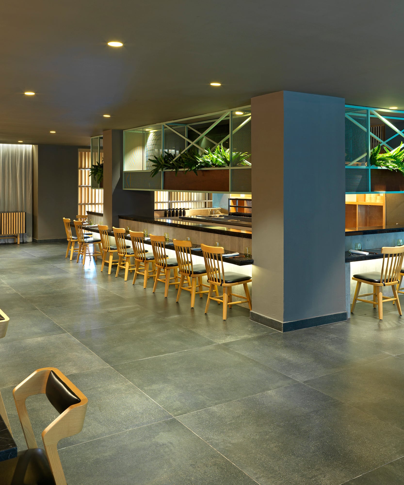 a room with a bar and chairs