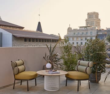 a patio with chairs and a table