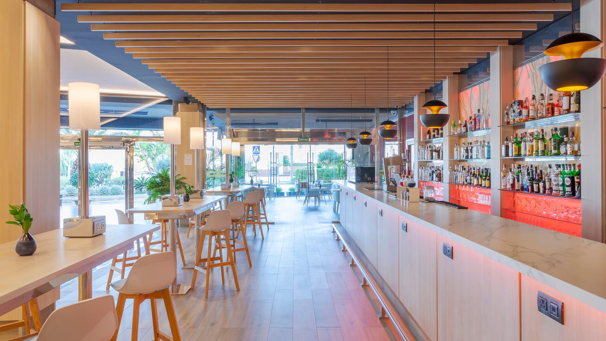 a bar with white tables and chairs