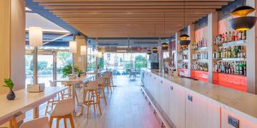 a bar with white tables and chairs