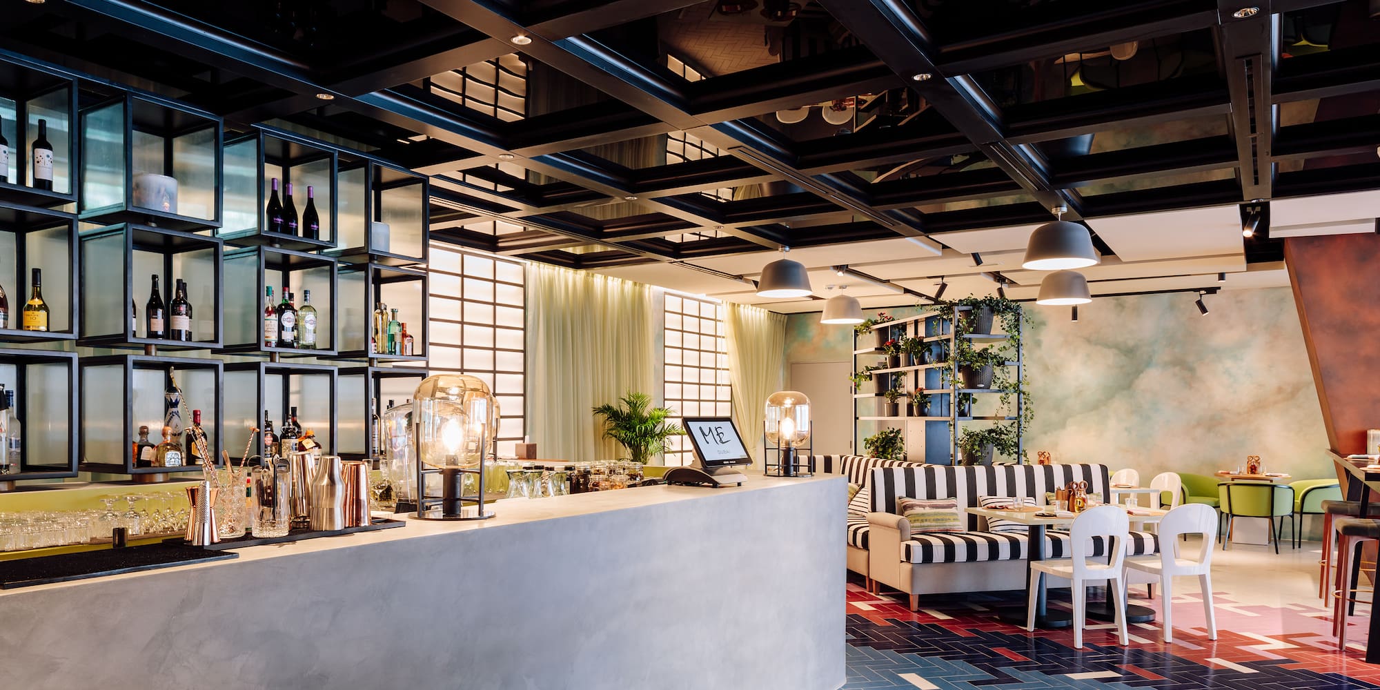 a bar with a black and white striped couch and a black and white striped couch