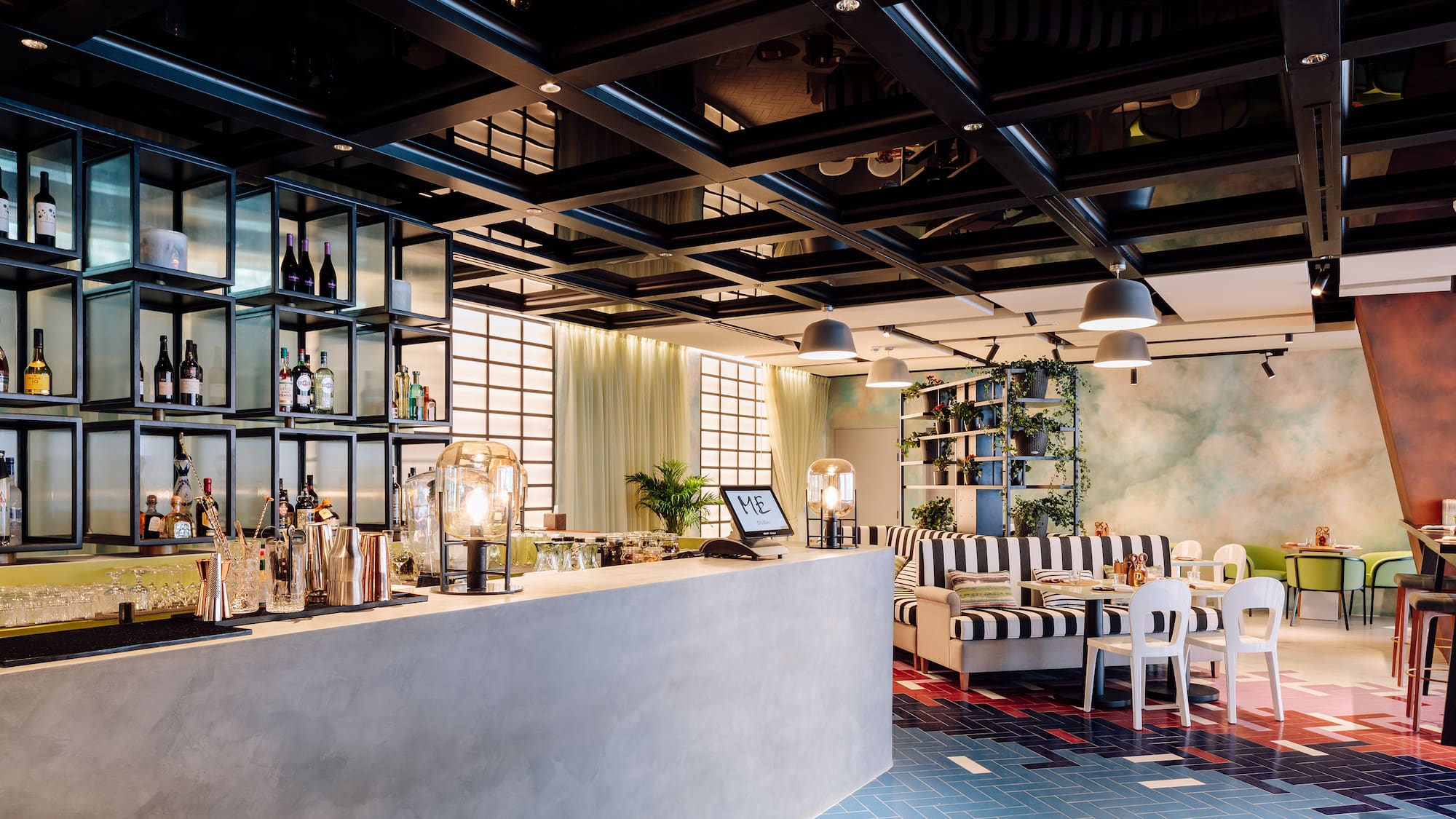 a bar with a black and white striped couch and a black and white striped couch