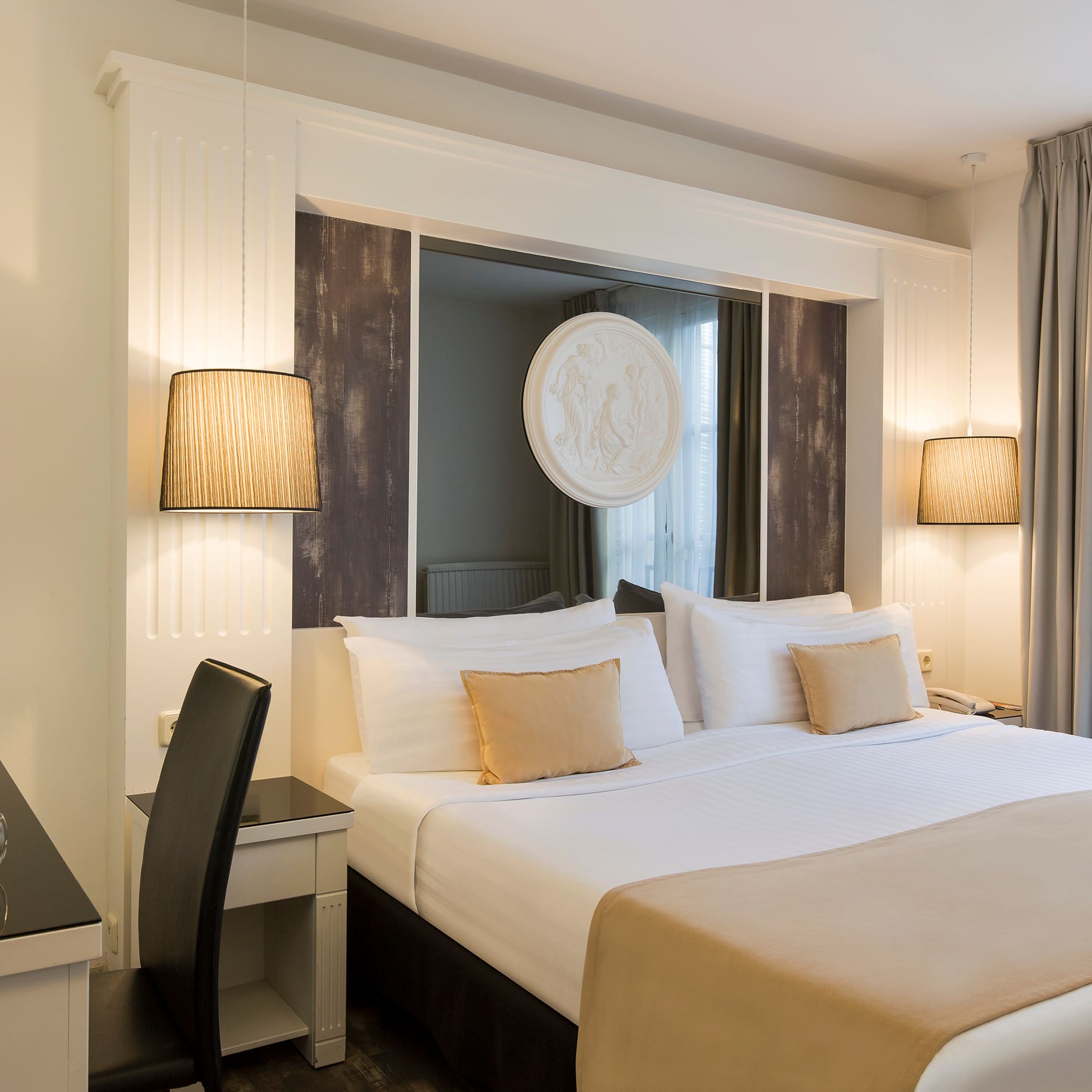 a bed with a lamp and a table