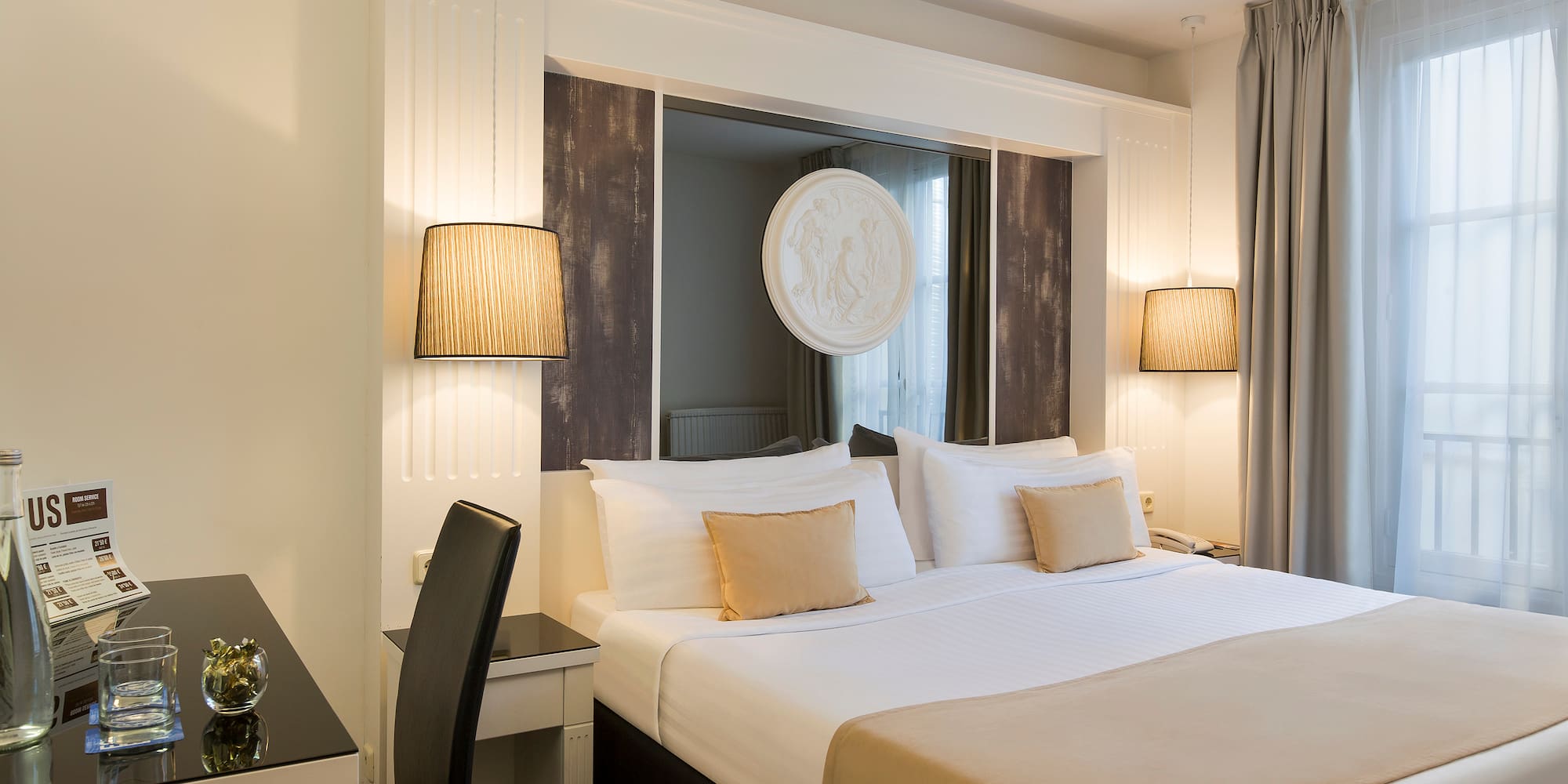 a bed with a lamp and a table