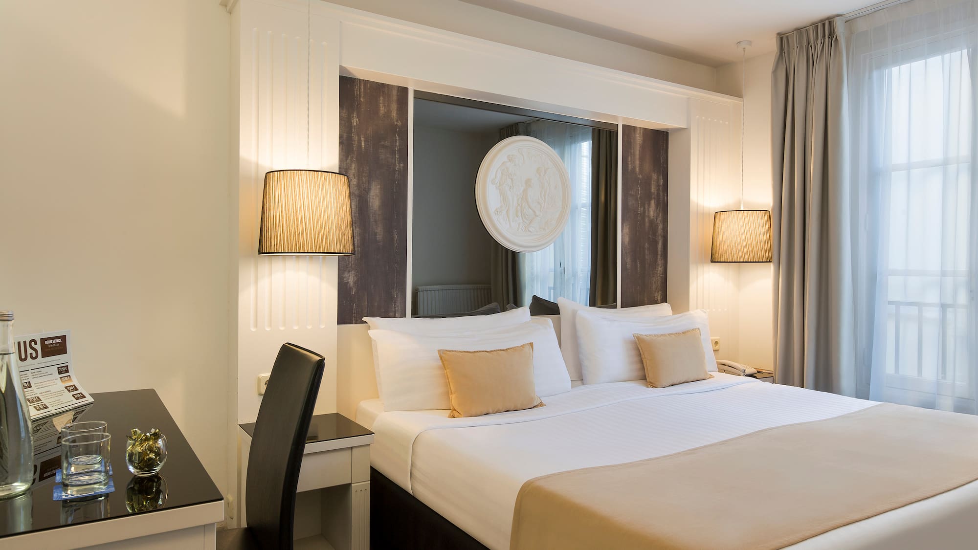 a bed with a lamp and a table