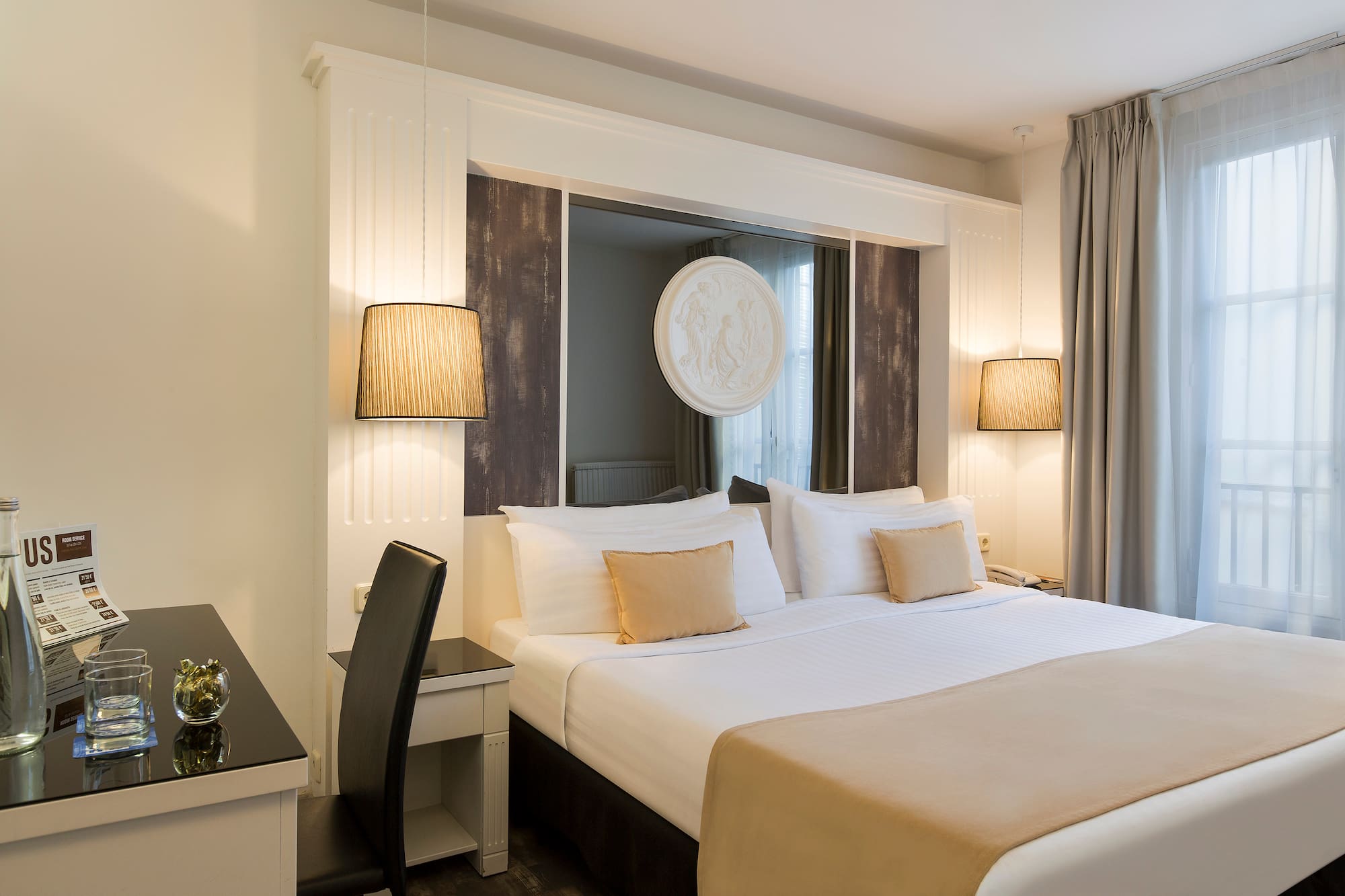 a bed with a lamp and a table