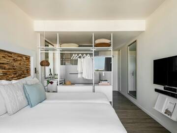 a room with a bed and a tv
