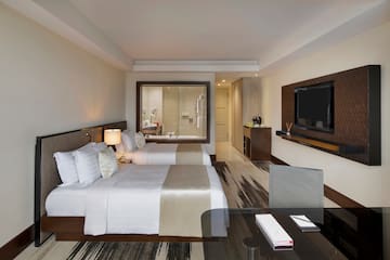 a room with two beds and a television
