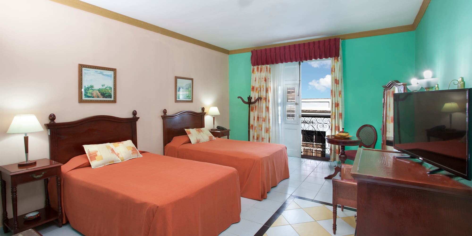 a room with two beds and a desk