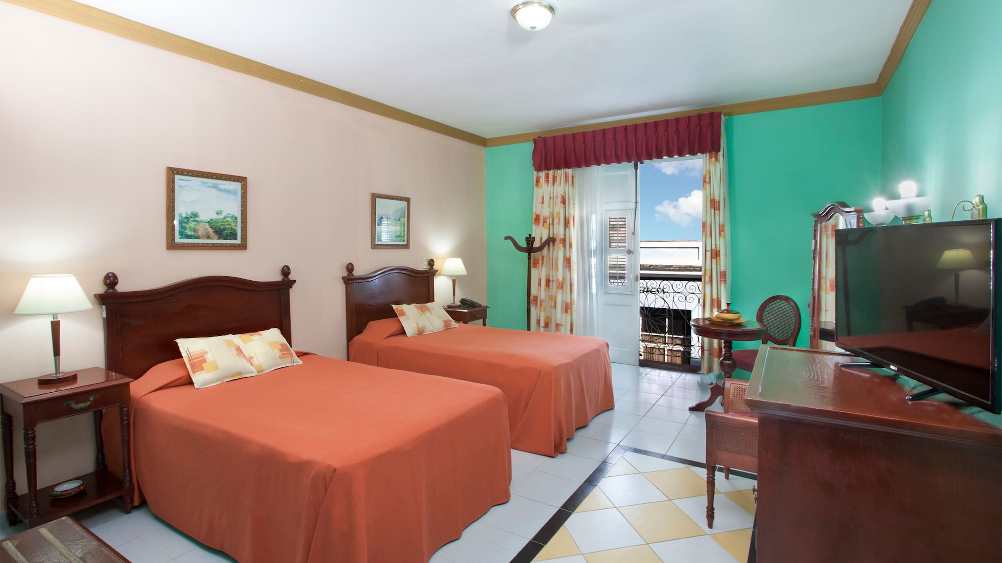 a room with two beds and a desk