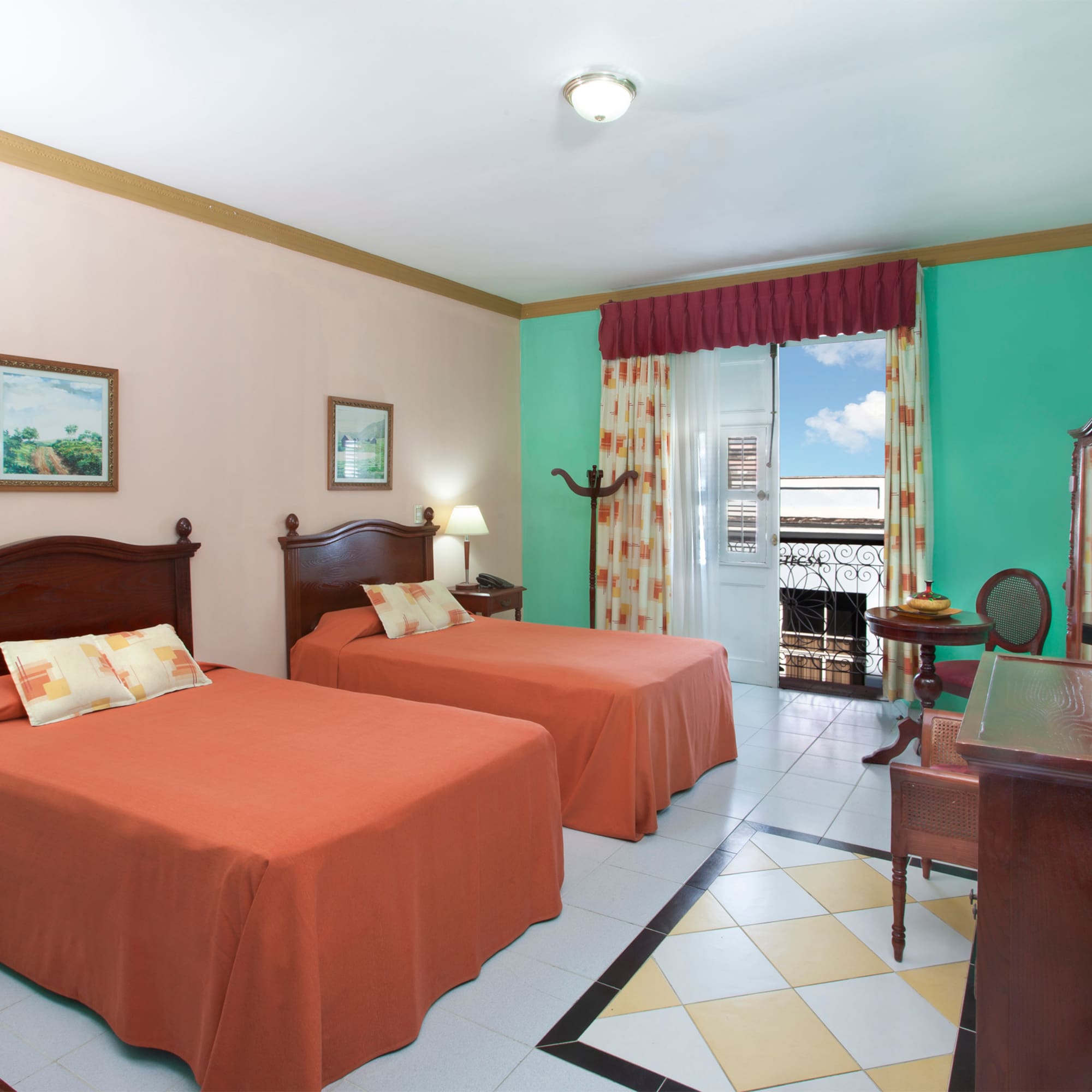 a room with two beds and a desk