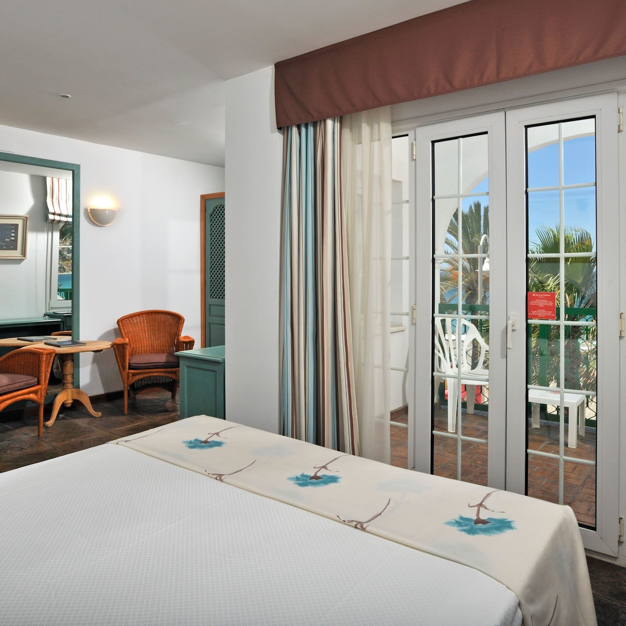 a room with a bed and glass doors